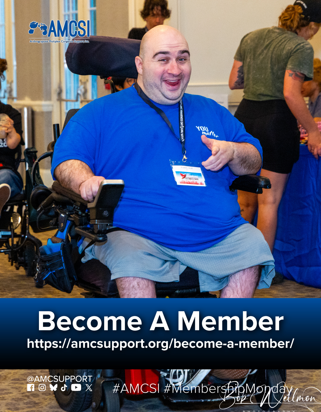AMCSI member using a power wheelchair smiles at the AMCSI Annual Conference beside a "Become A Member" message encouraging support for the Arthrogryposis community.